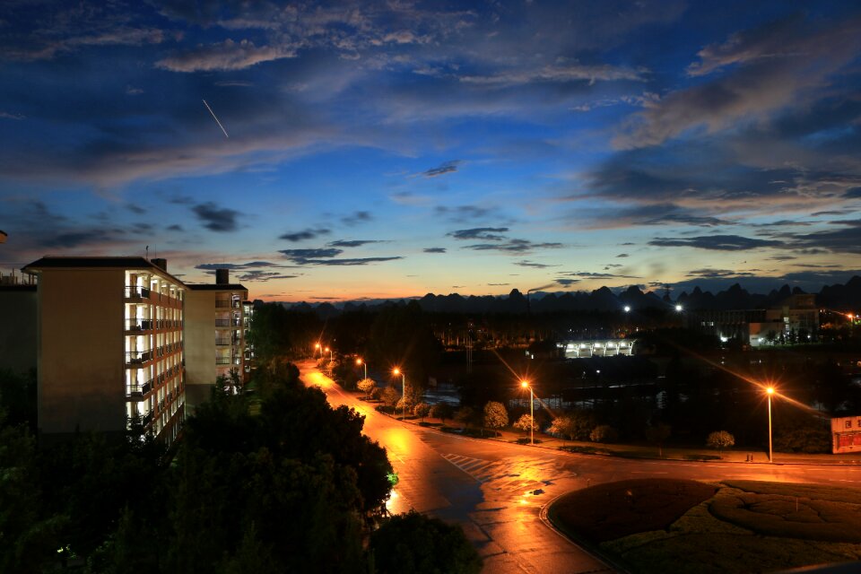 Sunset dark clouds street lights photo