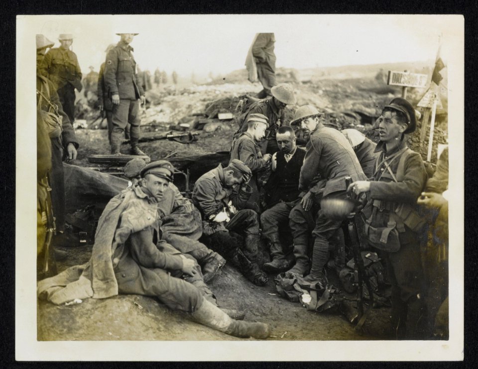 Canadian Red Cross man attending to German wounded at an advance dressing statio, Bestanddeelnr 158-1105
