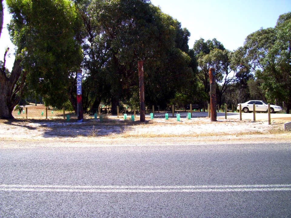 Carved heritage poles at Preston Beach town entrance from across Mitchell Road (E37@WTW2013)