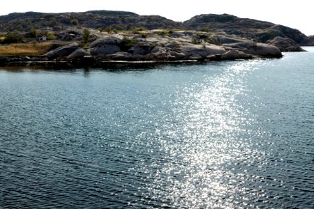 Cliffs and sun glitter in Norra Grundsund photo