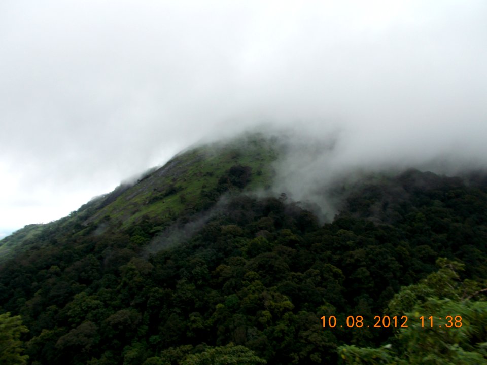 Cloud touching the tip of the mountain