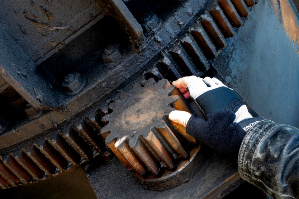 Cog wheel on a huge crane claw - size compaired to hand