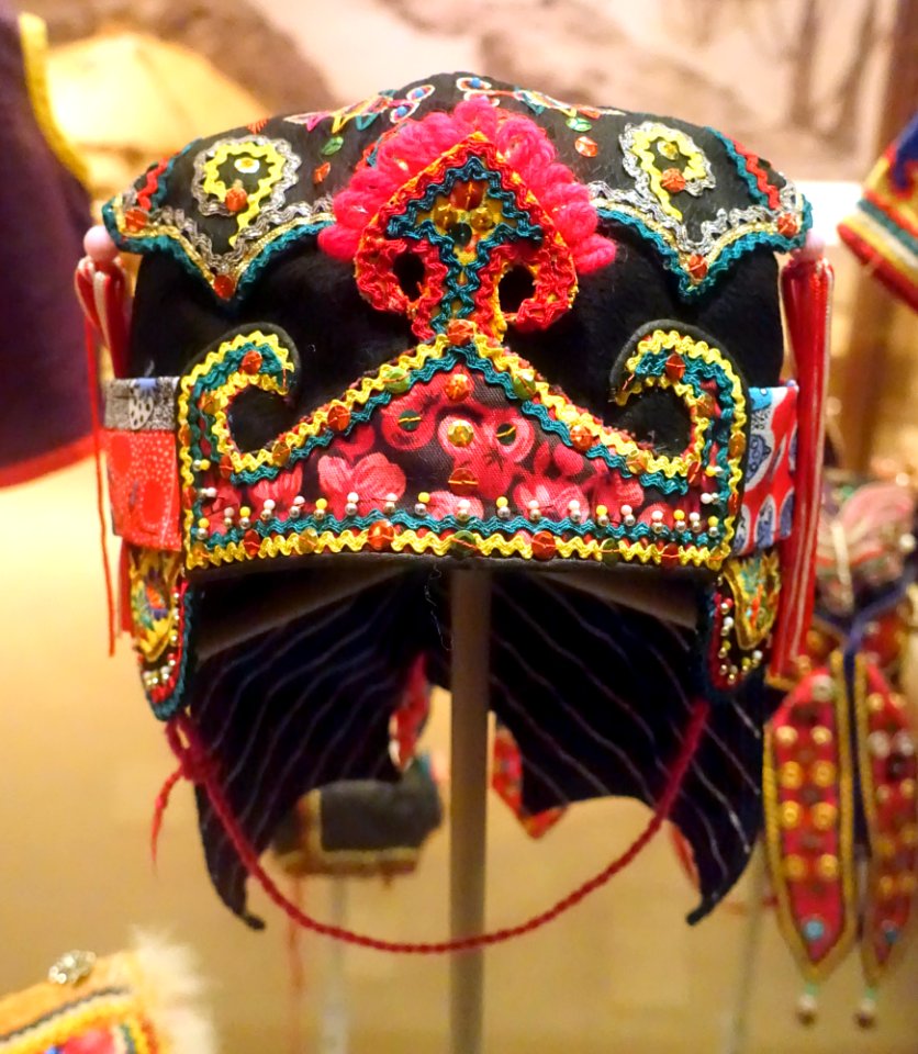 Child's 'wind hat' with ruyi decoration in front, trimmings and streamers, Hoklo - Hong Kong Museum of History - DSC00937