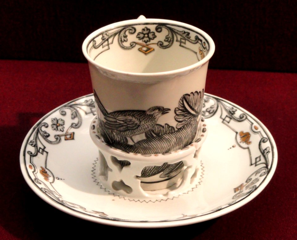Chocolate cup with trembleuse saucer, c. 1735-1740, Du Paquier factory, hard-paste porcelain, Schwarzlot overglaze black enamel, gilding - Gardiner Museum, Toronto - DSC01014