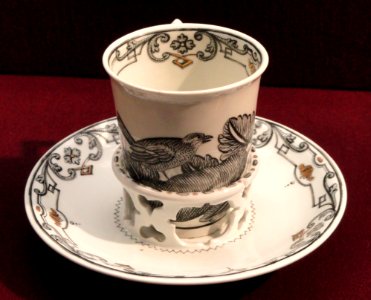 Chocolate cup with trembleuse saucer, c. 1735-1740, Du Paquier factory, hard-paste porcelain, Schwarzlot overglaze black enamel, gilding - Gardiner Museum, Toronto - DSC01014
