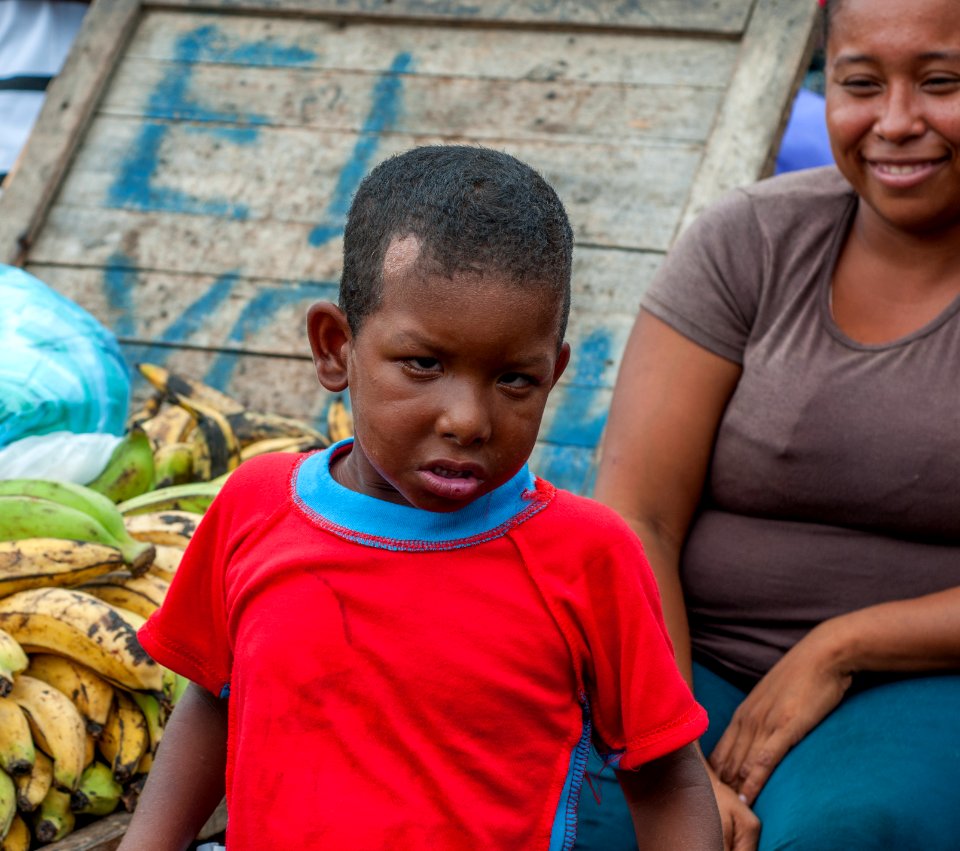 Child and his mother by selling bananas