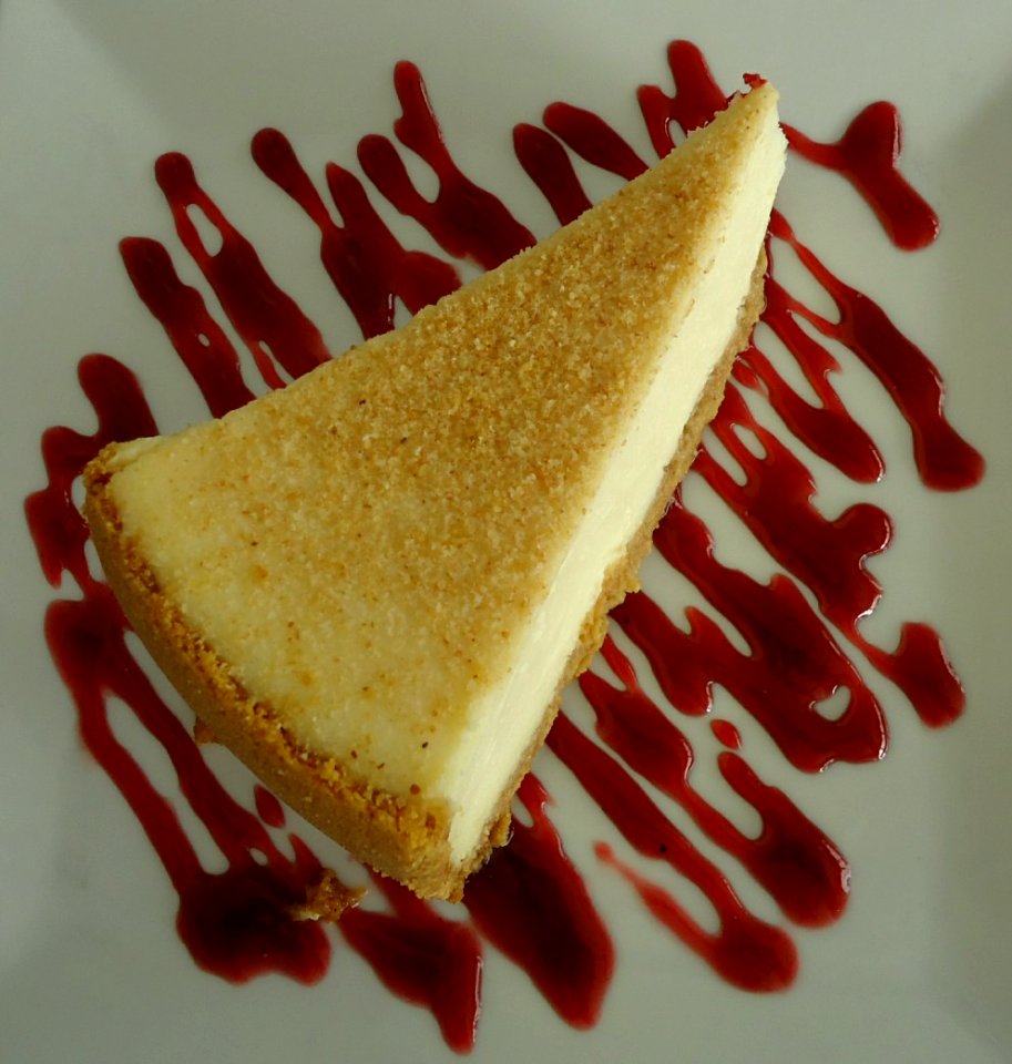 Cheesecake served with sauce in a restaurant