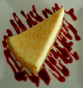 Cheesecake served with sauce in a restaurant photo