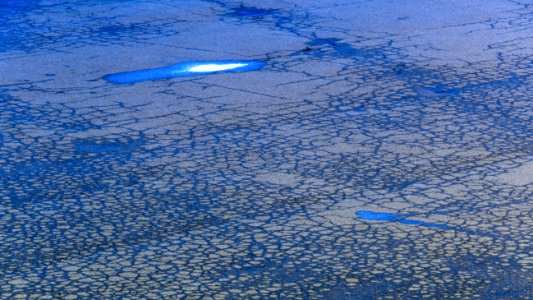 Cracked asphalt after rain at blue hour photo