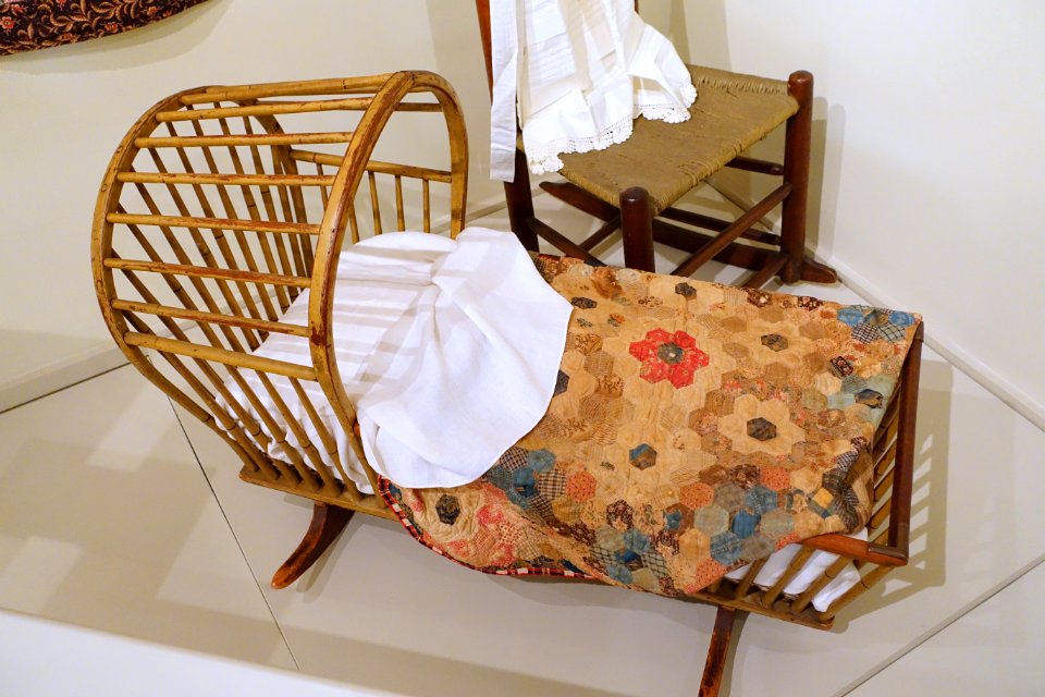 Cradle, Rhode Island, 1805-1815, pine, hickory, with cradle quilt made by Hannah Dawes Newcomb 1769-1851, Boston, 1835-1850, cotton, ribbon, paper - Concord Museum - Concord, MA - DSC05851