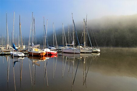 Morning haze water sports sail masts photo
