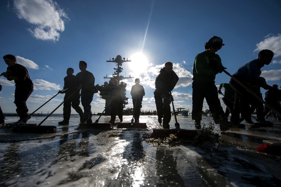 Silhouettes wash down flight deck