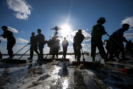 Silhouettes wash down flight deck