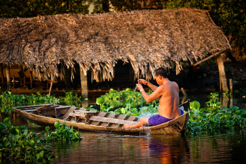 People fishing brown fish