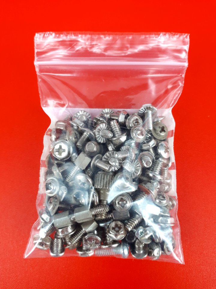 Computer screws in a zipper storage bag - 6 x 9 cm - on Red plastic