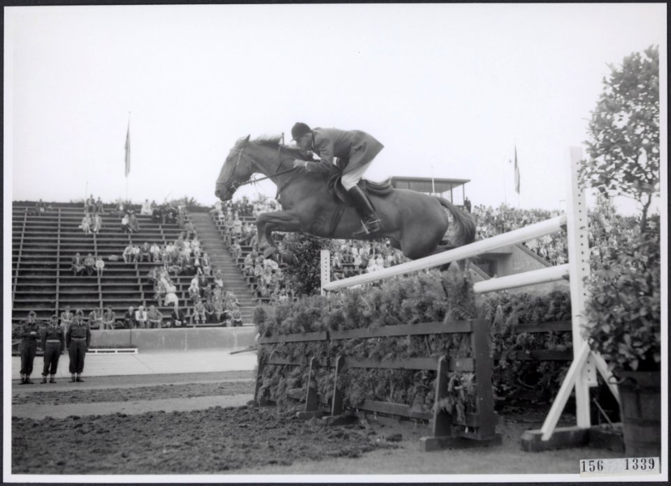 Concours Hippique Een ruiter met een springpaard neemt een hindernis, Bestanddeelnr 156-1339