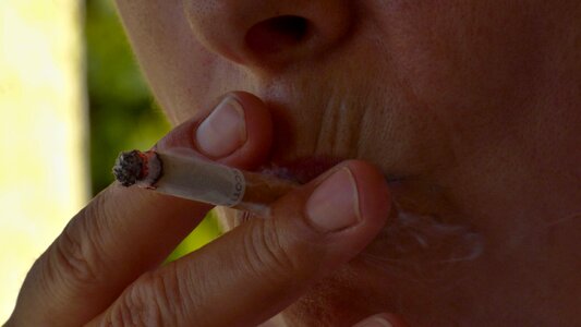 Cigarette fingers the mouth of the