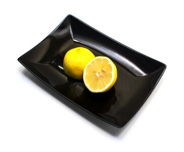 Citrus white background black plate photo