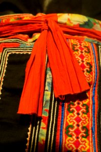 Costume, Hmong Hoa, Lao Cai, 1950, view 5, gown and apron in industrial cotton, skirt in three panels of help, trimmed in batik patterns - Vietnamese Women's Museum - Hanoi, Vietnam - DSC03770