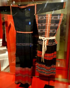 Costumes, (left) E De, Dac Lac, 1970, handmade cotton & natural dyes, (right) Co-tu, Quang Nam, 1980, handmade cotton, indigo, beads strung on weft - Vietnamese Women's Museum - Hanoi, Vietnam - DSC04067