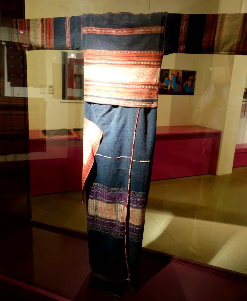 Costume, Bahnar, Binh Dinh, 1970, view 1, handmade cotton, natural dyes, ikat & woven patterns, shirt with stars and insect eyes, skirt with Job's Tears seeds - Vietnamese Women's Museum - Hanoi, Vietnam - DSC03940