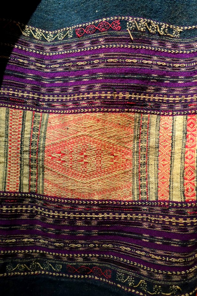 Costume, Bahnar, Binh Dinh, 1970, view 5, handmade cotton, natural dyes, ikat & woven patterns, shirt with stars and insect eyes, skirt with Job's Tears seeds- Vietnamese Women's Museum - Hanoi, Vietnam - DSC03949