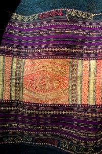 Costume, Bahnar, Binh Dinh, 1970, view 5, handmade cotton, natural dyes, ikat & woven patterns, shirt with stars and insect eyes, skirt with Job's Tears seeds- Vietnamese Women's Museum - Hanoi, Vietnam - DSC03949