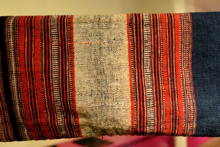Costume, Bahnar, Binh Dinh, 1970, view 4, handmade cotton, natural dyes, ikat & woven patterns, shirt with stars and insect eyes, skirt with Job's Tears seeds- Vietnamese Women's Museum - Hanoi, Vietnam - DSC03947