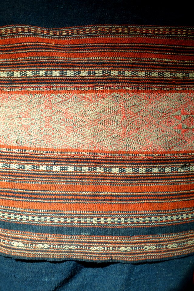 Costume, Bahnar, Binh Dinh, 1970, view 2, handmade cotton, natural dyes, ikat & woven patterns, shirt with stars and insect eyes, skirt with Job's Tears seeds- Vietnamese Women's Museum - Hanoi, Vietnam - DSC03942