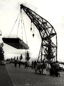 Conrad Stork. De drijvende kraan (drijvende Bok) met een last aan de Spaarndamseweg, nabij de Floresstraat ziende naar het noorden. Aangekocht in 1977 van fotograaf C. de Boer. Identificatie, NL-HlmNHA 54010641