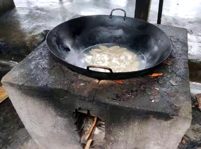 Cooking with a wok on an outdoor stove 2 photo
