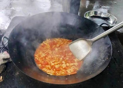 Cooking with a wok on an outdoor stove 5 photo