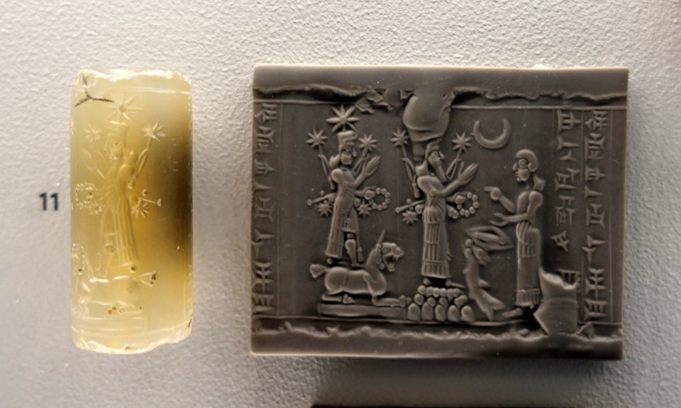 Deities and worshipper, cylinder seal inscribed 'belonging to Ubashi... eunuch of Piqitti-ilima', Neo-Assyrian, c. 883-612 BC, smoky chalcedony - Sackler Museum - Harvard University - DSC01723