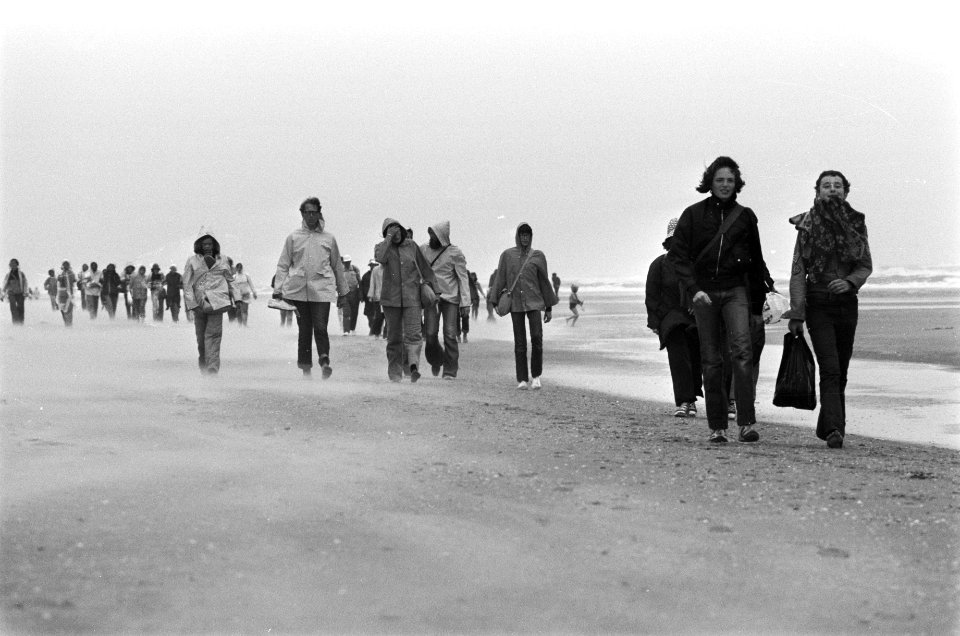Deelnemers wandelen in de regen op het strand, Bestanddeelnr 928-0636
