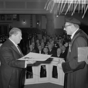 De promotor prof. J. H. van den Broek (r) reikt de heer G.Th. Rietveld, Bestanddeelnr 915-9349