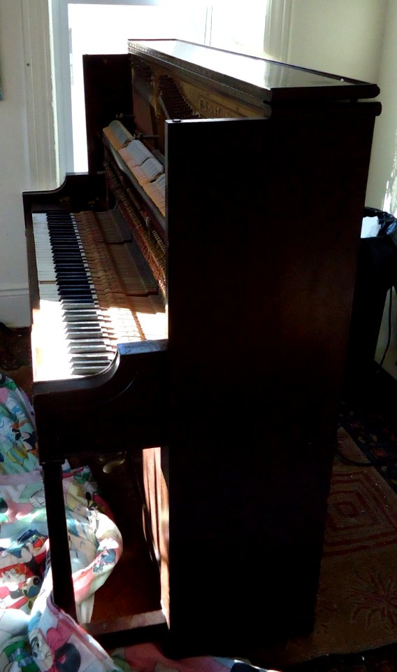 Demolition of upright Knabe piano in living room