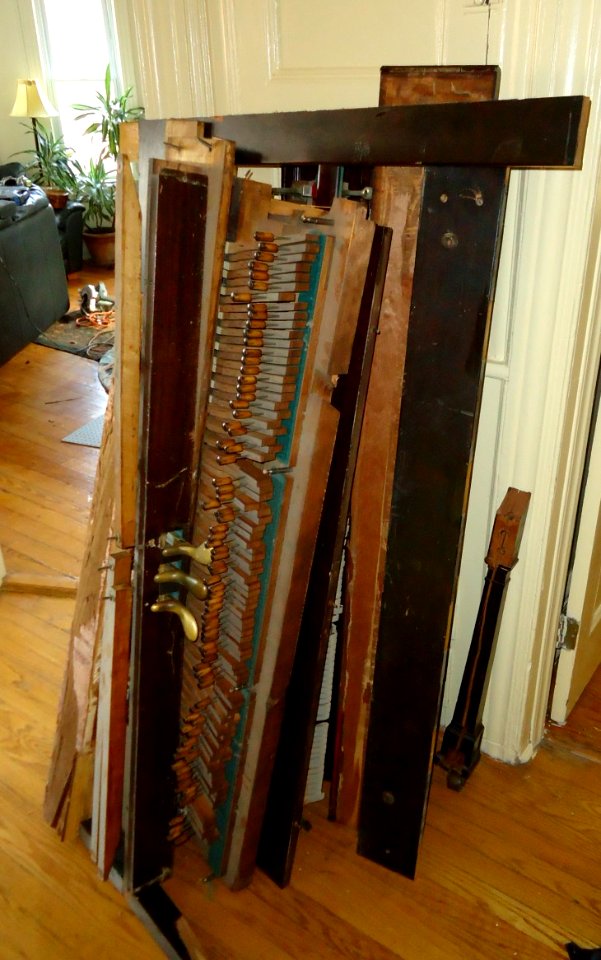 Demolition of upright Knabe piano parts in hallway