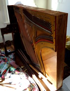 Demolition of upright Knabe piano keyboard and hammers removed photo