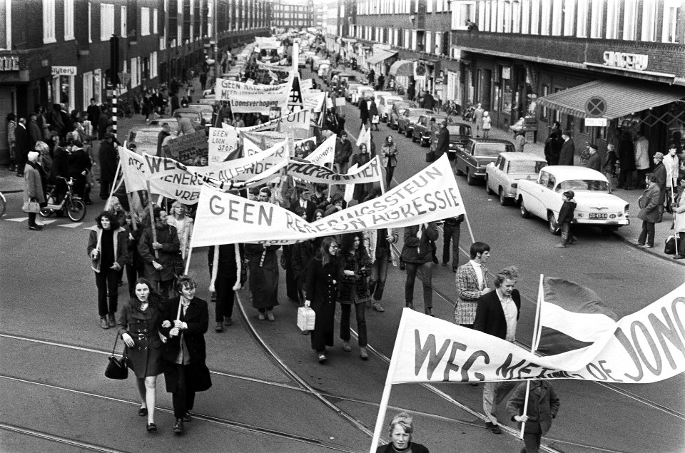 Demonstranten trekken met vlaggen en spandoeken door de straten van Amsterdam, Bestanddeelnr 924-3998