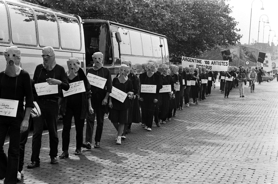 Demonstranten in Amsterdam, met kappen op, voeren borden met daarop de namen van, Bestanddeelnr 931-6771