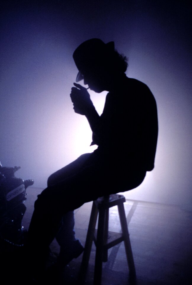 Silhouette sitting against day