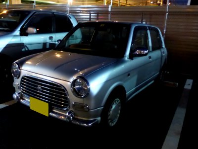Daihatsu MIRA Gino (L700S) at night front