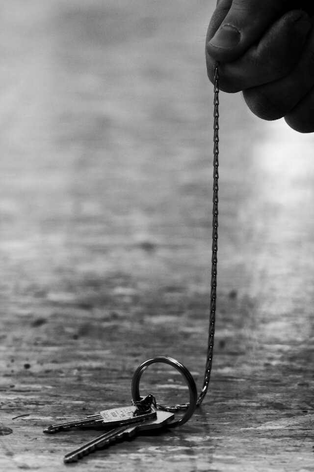 Man hand gray key