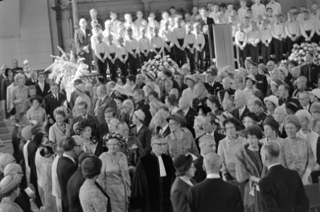 De Koninklijke familie wandelt temidden van andere kerkgangers de kerk binnen. O, Bestanddeelnr 921-6653