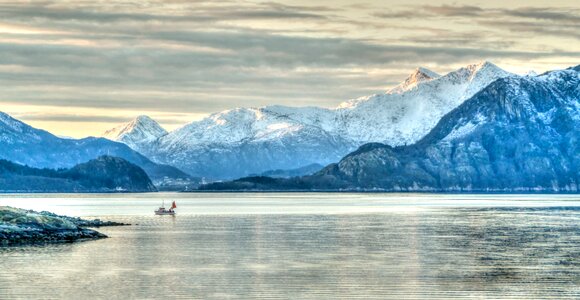 Winter snow cloudy sky fjord photo