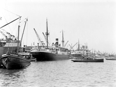 De haven van Amsterdam, de MS Cottica, stuurboordzijde, met sleepboot, in het ve, Bestanddeelnr 190-0240