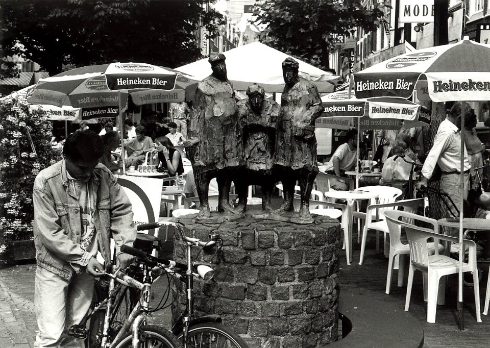 De Grote Houtstraat met het beeldje Winkelen of Stadten, met drie winkelende vrouwen. Aangekocht van United Photos de Boer bv. - Negatiefnummer 34941 k 26. - Gepubliceerd in het Haarlems Dagblad van 0