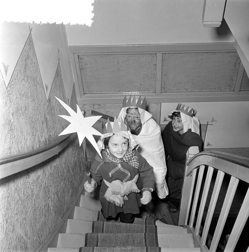 Driekoningen. Kinderen verkleed als de drie koningen in een woning onderaan een , Bestanddeelnr 934-5264