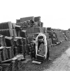 Drooglegging van de Wieringermeerpolder Man bij stapels bakstenen, Bestanddeelnr 900-8323
