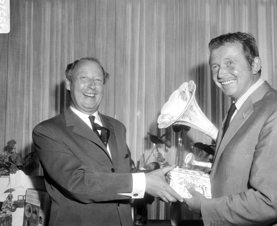 Dhr. G.M. van Oord (dir. Bovema (l) laat Toon Hermans een zeldzame porceleinen g, Bestanddeelnr 919-5725